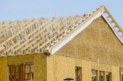Photo of roof trusses newly installed on a home that is being built. 